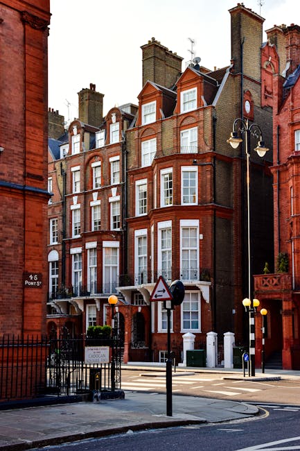Photo of a historic building in Knightsbridge with ornate stone facades and large arched windows at street level, featuring decorative detailing and a vertical sign spelling 'FEARROADS' on the corner. The building is illuminated by soft natural light, with a clear sky background. A street lamp and an underground station sign are visible nearby, indicating a busy urban area. This architectural setting highlights the need for routine surface cleaning and maintenance to preserve its detailed external surfaces, which local experts like Knightsbridge Carpet Cleaning can help ensure stay in good condition for residents and visitors alike.